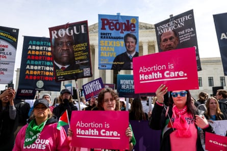 Abortion rights demonstrators gather outside the US supreme court in Washington DC holding pink signs reading ‘abortion is health care’