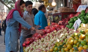 Yasmin Khan choosing pomegranates, the nations favourite fruit, at an Iranian market.