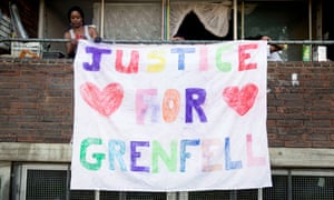 Residents of the Lancaster West estate, which is part of the same estate as the Grenfell Tower put up a Justice for Grenfell sign from their balcony.