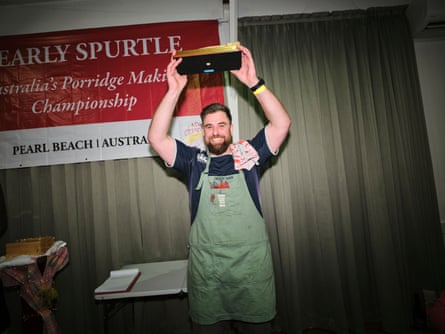 Robby Reid holds trophy above his head