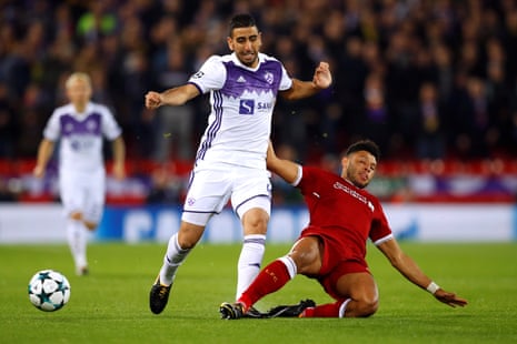 Liverpool’s Alex Oxlade-Chamberlain slides in to dispossess Maribor’s Marwan Kabha.