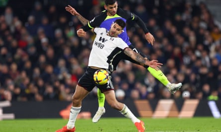 Aleksandar Mitrovic of Fulham and Cristian Romero of Tottenham battle for the ball.