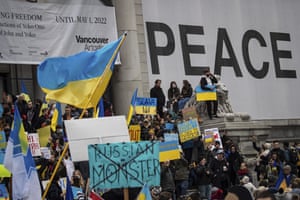 People hold signs and wave flags as thousands gather for a rally in support of the people of Ukraine, in Vancouver, British Columbia. People hold signs and wave flags as thousands gather for a rally in support of the people of Ukraine, in Vancouver, British Columbia.