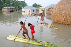 Children paddle rafts through the streets in Kurigram District, Bangladesh, September 2015.