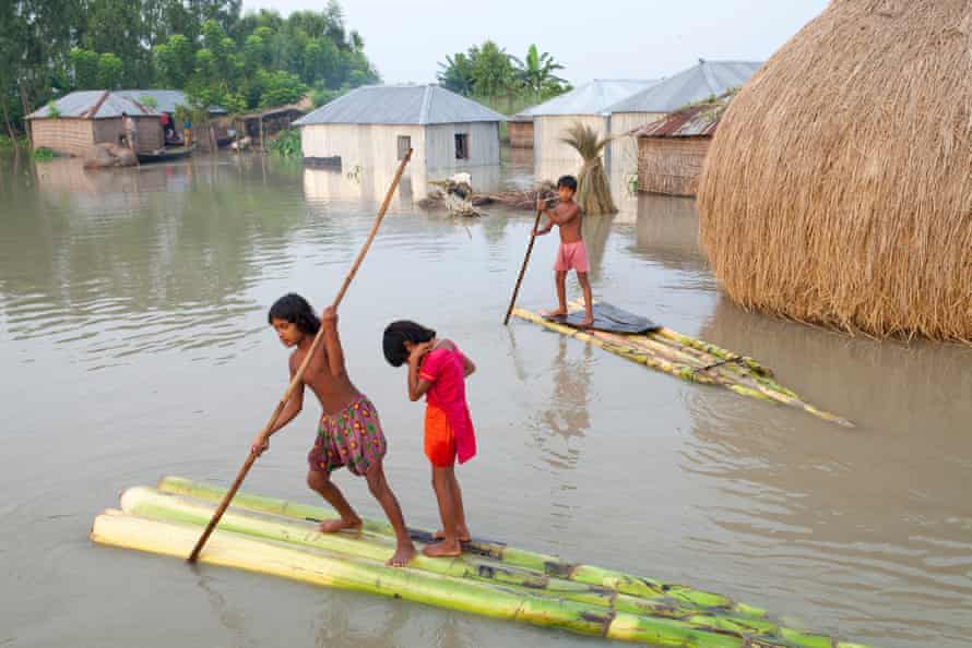 Children paddle rafts through the streets in Kurigram District, Bangladesh, September 2015.