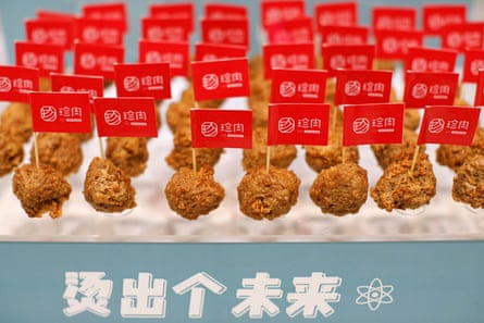 Rows of plant-based meatballs, each with a branded Zhenmeat flag in it