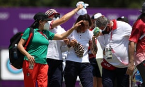 People help Russian archer Svetlena Gombaeva after she felt faint in the heat as temperatures soared at the Olympics