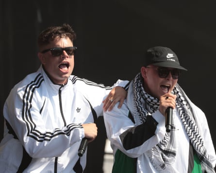 Two members of Kneecap on stage