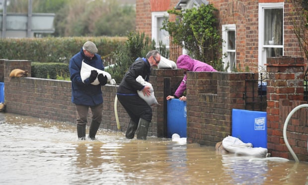 Residents of Tewkesbury, Gloucestershire stack sandbags in the aftermath of Storm Dennis, expecting more rain