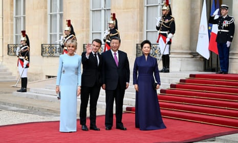 France's President Emmanuel Macron and his wife Brigitte Macron welcoming Chinese President Xi Jinping and his wife Peng Liyuan at the Elysee Palace in Paris on Monday.