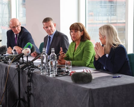 The party leaders sat at a table during a press conference