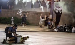 People help a protester after he was shot with a rubber bullet under Interstate 35 freeway in Austin in May 2020.