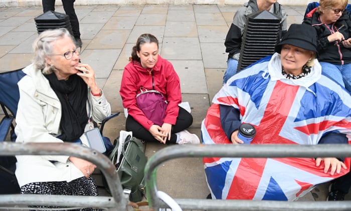 People take place behind fences ahead of the procession.