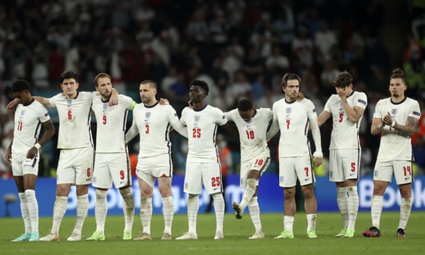England players react during the penalty shootout at the Euro 2020 final between England and Italy at Wembley stadium in London, Sunday, July 11, 2021. 