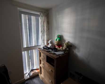 A window in a child’s bedroom largely obscured by metal sheets outside it