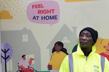Yaw Botwe, who says JobsPlus helped him get the first job he has ever liked doing, stands next to a mural at the community centre.