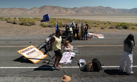 protesters hold signs on road