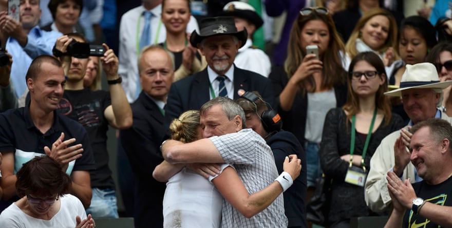 Petra Kvitova of the Czech Republic embraces her father Jiri after defeating Eugenie Bouchard of Canada in their women’s singles final tennis match at the Wimbledon Tennis Championships, in London July 5, 2014.