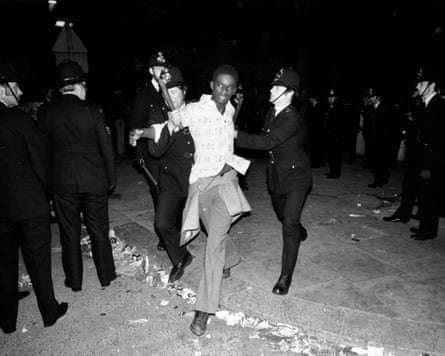 Police arresting a young man during riots at the carnival in 1976.