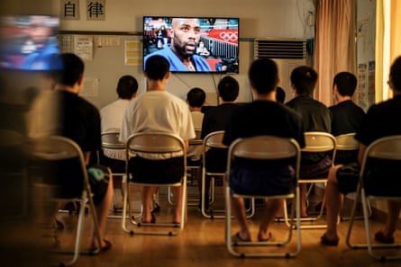 Boys, who have committed crimes, watch a recorded news digest of the Tokyo 2020 Olympic Games at a juvenile training school in Tokyo on August 5