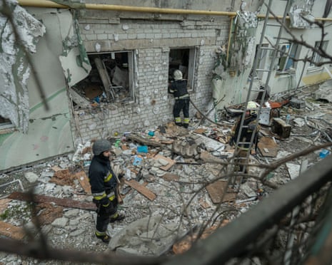 Rescuers clear the rubble in the destroyed apartment building after the Russian drone attack in Kharkiv, Ukraine.