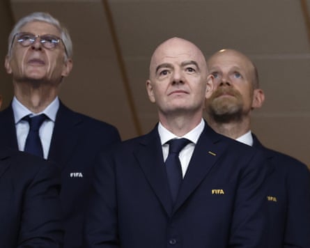 Gianni Infantino watches the World Cup semi-final match between England and Argentina, flanked by Arsène Wenger (left) and Mattias Grafström (right).