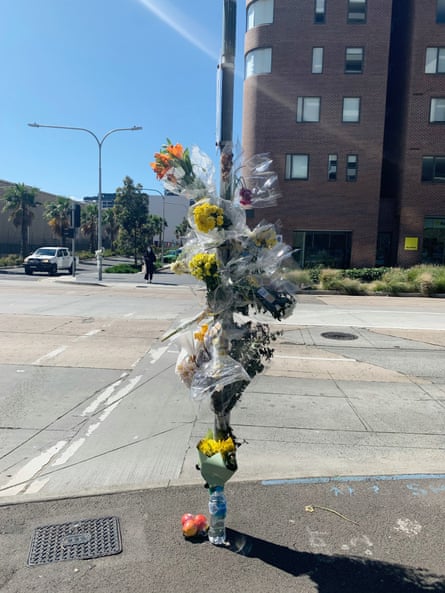 Flowers left in Zetland near where food delivery rider Xiaojun Chen was killed in Sydney in a collision.