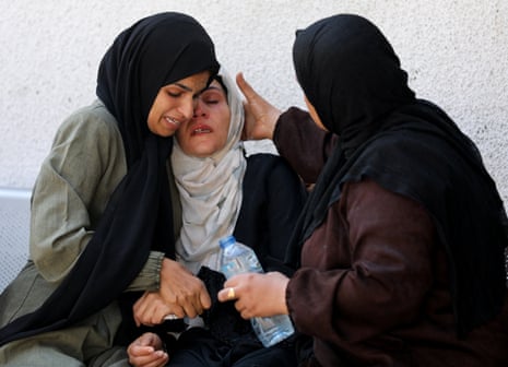 Mourners react during the funeral of Palestinians killed by Israeli fire, according to the Gaza health ministry, near an aid distribution center in central Gaza, at Al-Shifa hospital, in Gaza City, June 10, 2025.