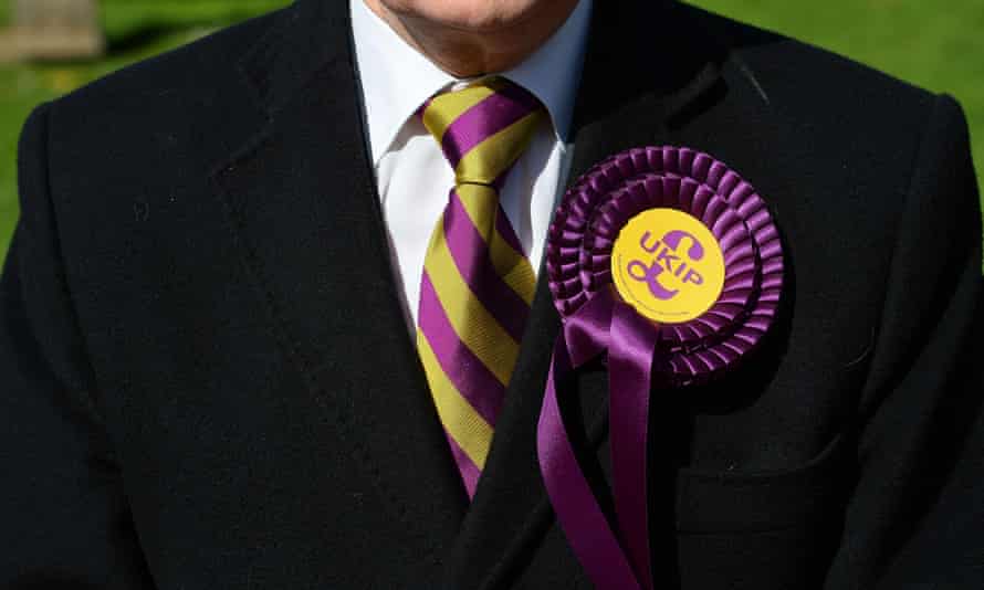 A voter wears a Ukip rosette as he stands outside a polling station in Brighton.