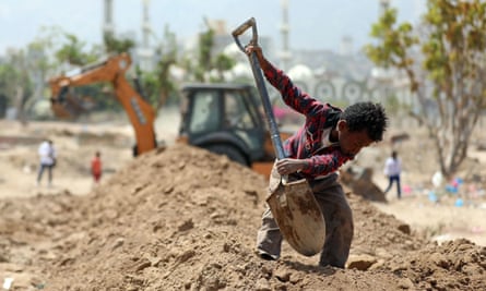A Yemeni boy digs at a cemetery in Taiz. Yemen is facing a second wave of Covid.