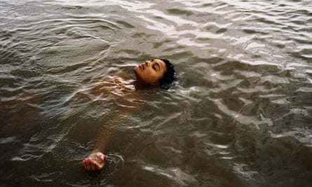 A young woman swimming on her back.