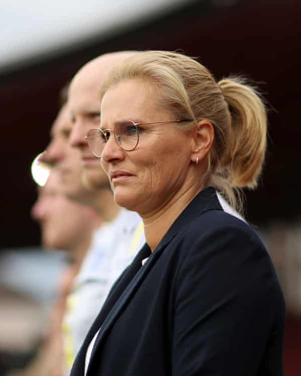 Sarina Wiegman, wearing glasses and hair in a ponytail, with a slight grimace