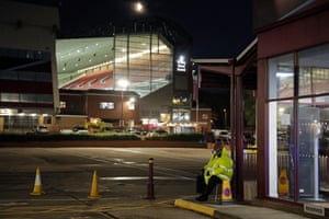 A steward sits in an empty car park at Villa Park before Aston Villa v Leeds on 23 October.