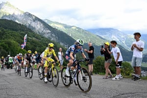 Supporters applaud as yellow jersey holder Pauline Ferrand-Prévot and other riders climb the Joux Plane pass