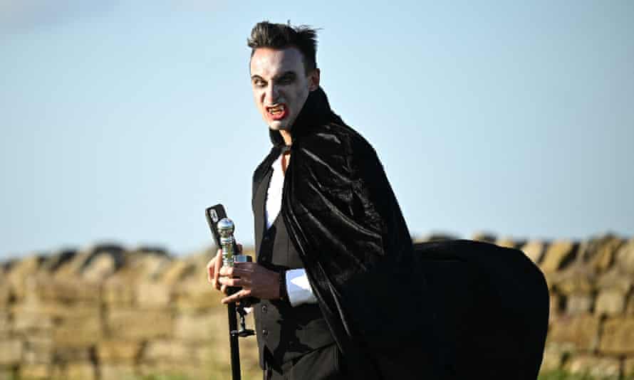 Man dressed as a vampire with a walking cane
