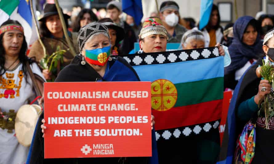 Indigenous leaders march in ceremonial dress from Glasgow's Green Park to the Cop26 Scottish Event Campus