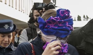 The teenager covers her face as she arrives at Famagusta district court, Cyprus.