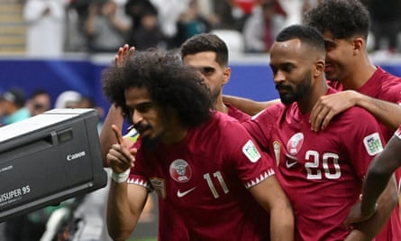 Qatar’s Akram Afif celebrates his winning penalty against Palestine