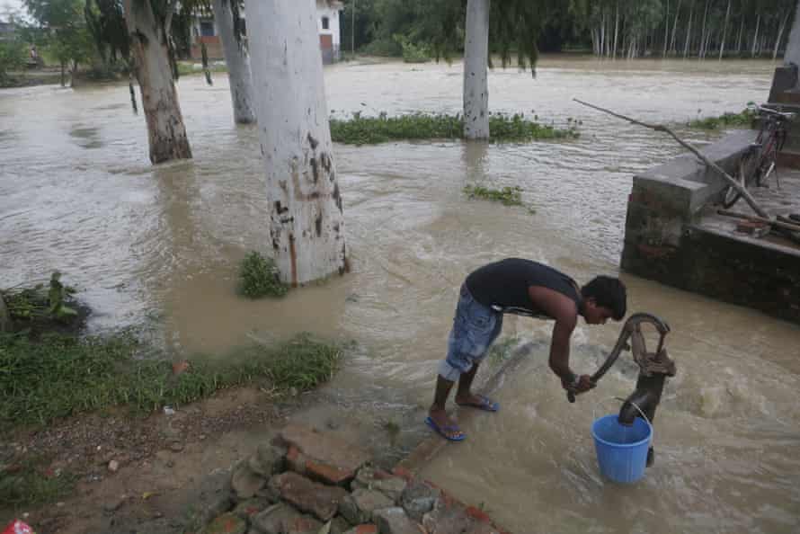 A boy tries to collect drinking water in Janakpur, Nepal
