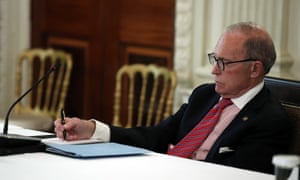 Larry Kudlow, White House chief economic adviser, takes notes as Donald Trump speaks about reopening the country on 29 April.