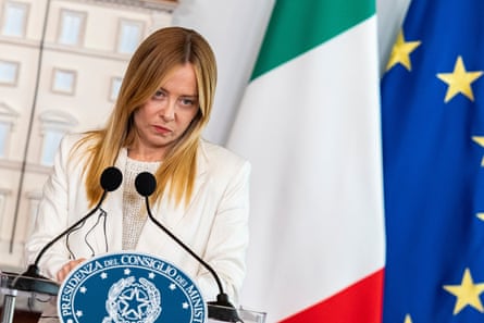 Meloni gives press conference with Italian and EU flags behind