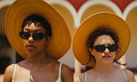 film still of two women wearing sunglasses and straw hats