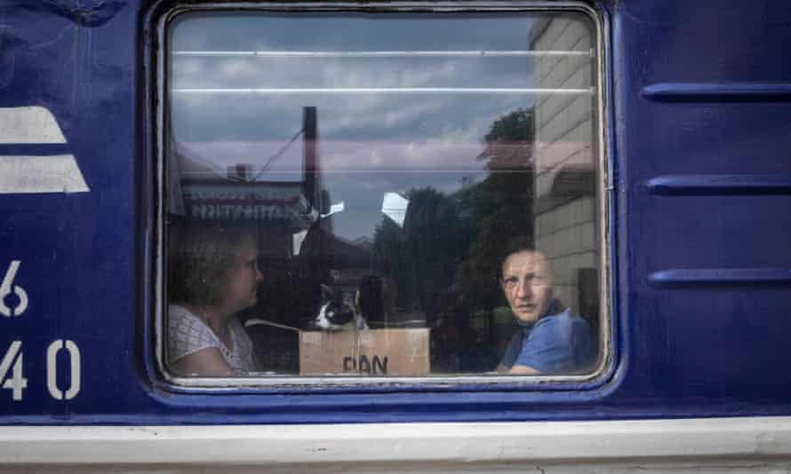 Passengers and a cat in a box on a train in Pokrovsk train station