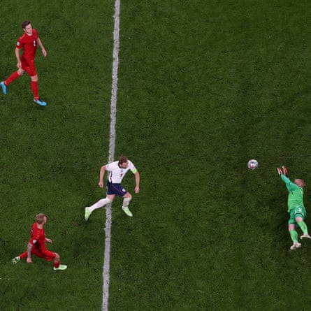 Harry Kane of England scores past Kasper Schmeichel of Denmark from the rebound of a missed penalty.