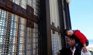 A family meets loved ones at the border fence. The border patrol do not publicize the place as a meeting point.