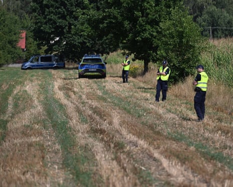 Services secure the area of a cornfield where an unidentified object fell in Osiny, eastern Poland.