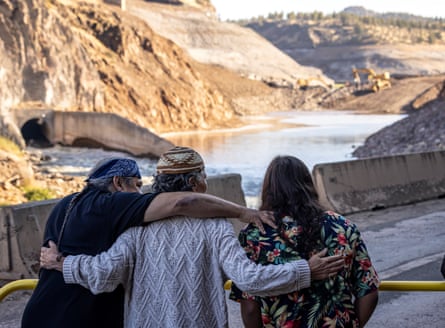 people with their arms around each other in front of a river valley