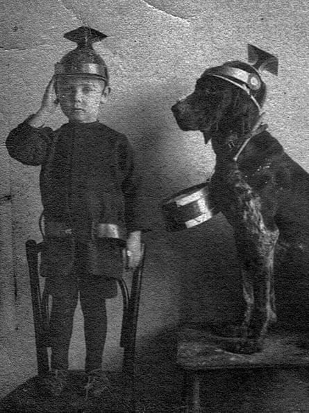 Six-year-old Stefan on 20 August 1914 wearing an Austrian helmet and uniform given to him as a gift. He is pictured with his pet dog in pre-independence Poland