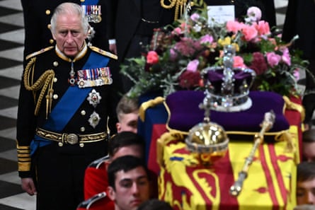 Britain’s King Charles III (L) walks beside the coffin of his mother, Queen Elizabeth II, draped in a Royal Standard and adorned with the Imperial State Crown and the Sovereign’s orb and sceptre as it leaves Westminster Abbey in London, UK, September 19 2022