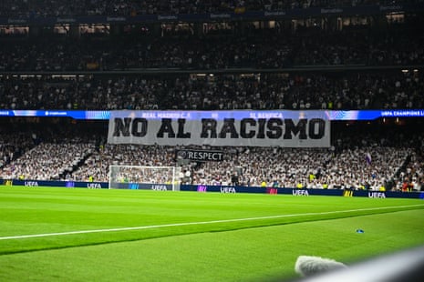 Real Madrid fans display a 'No to Racism' banner